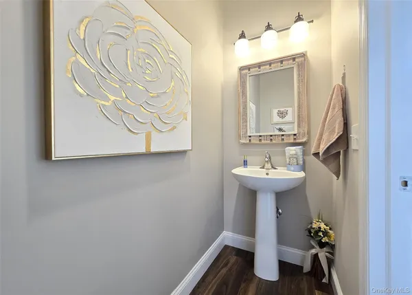 a bathroom with a sink a mirror and a toilet