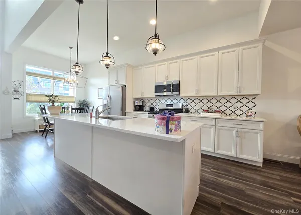 a large kitchen with stainless steel appliances kitchen island a large island in the center