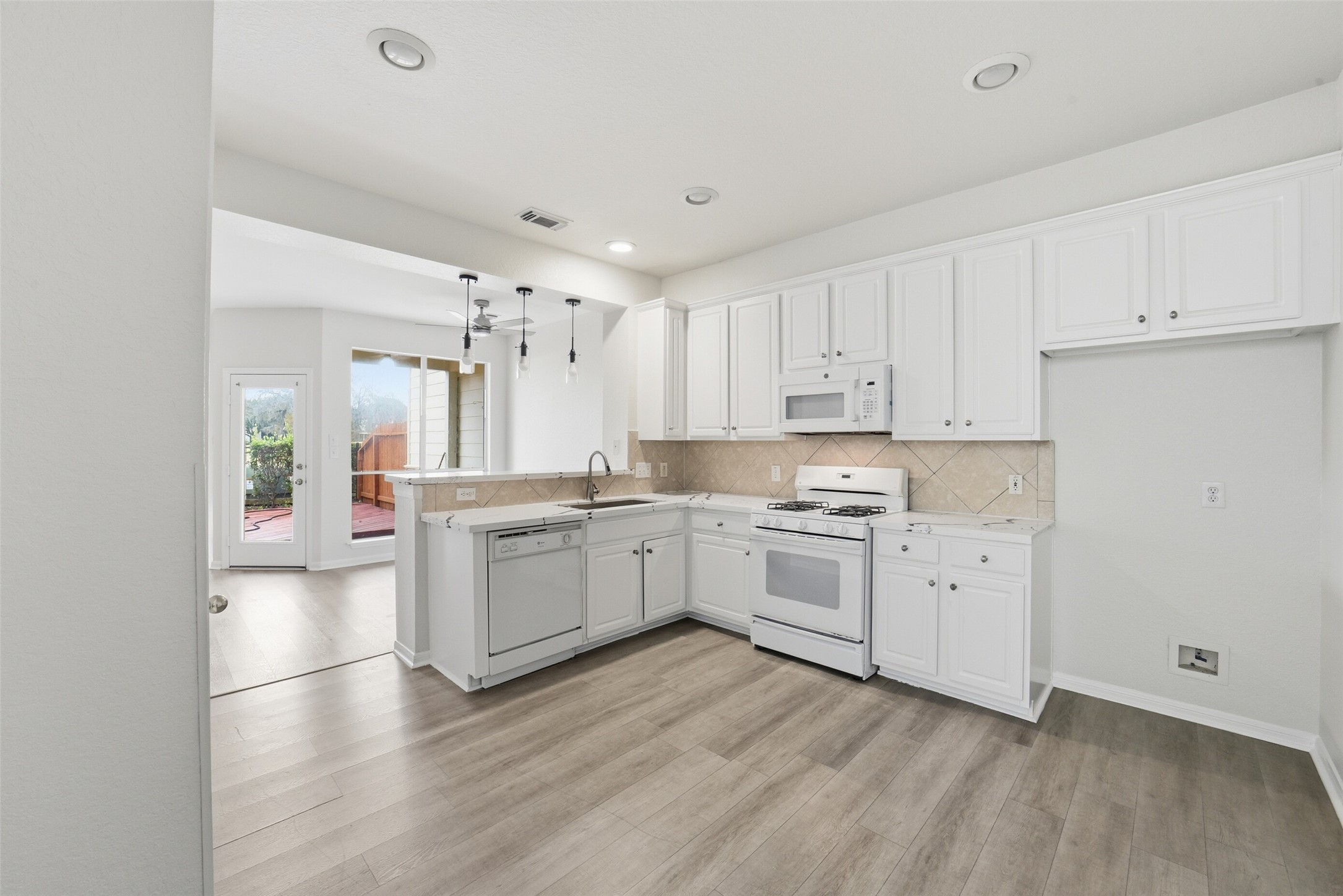 2110 Ridge Wood Lane Sugar Land, TX 77479 - Photo 11 of 26 a kitchen with a white cabinets and wooden floor