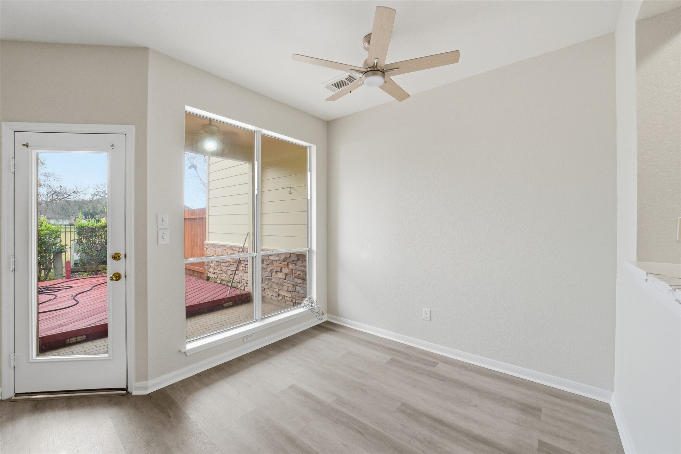 2110 Ridge Wood Lane Sugar Land, TX 77479 - Photo 12 of 26 an empty room with wooden floor fan and windows
