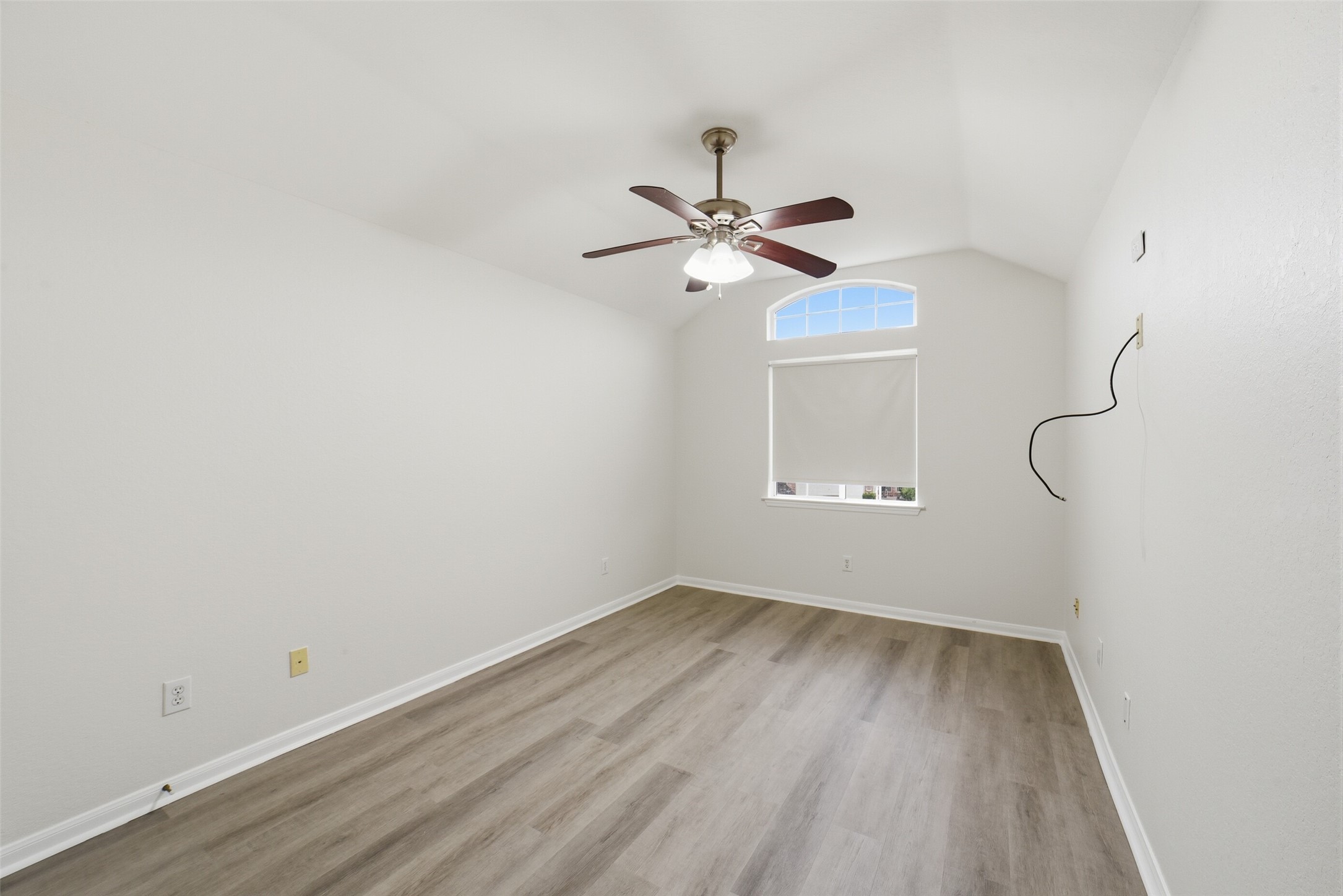2110 Ridge Wood Lane Sugar Land, TX 77479 - Photo 20 of 26 a view of a room with wooden floor and a ceiling fan
