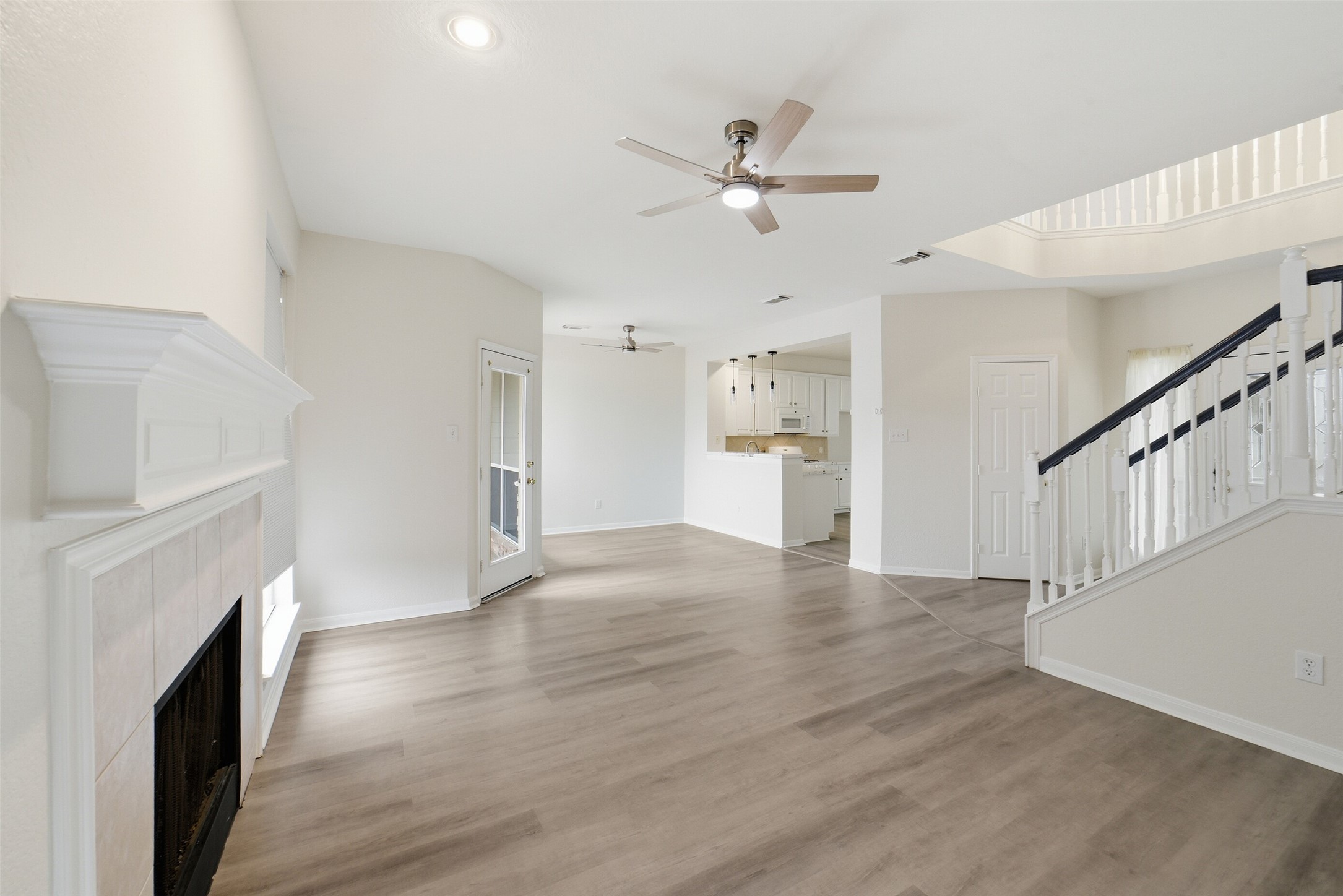 2110 Ridge Wood Lane Sugar Land, TX 77479 - Photo 4 of 26 a view of an empty room with wooden floor and a fireplace