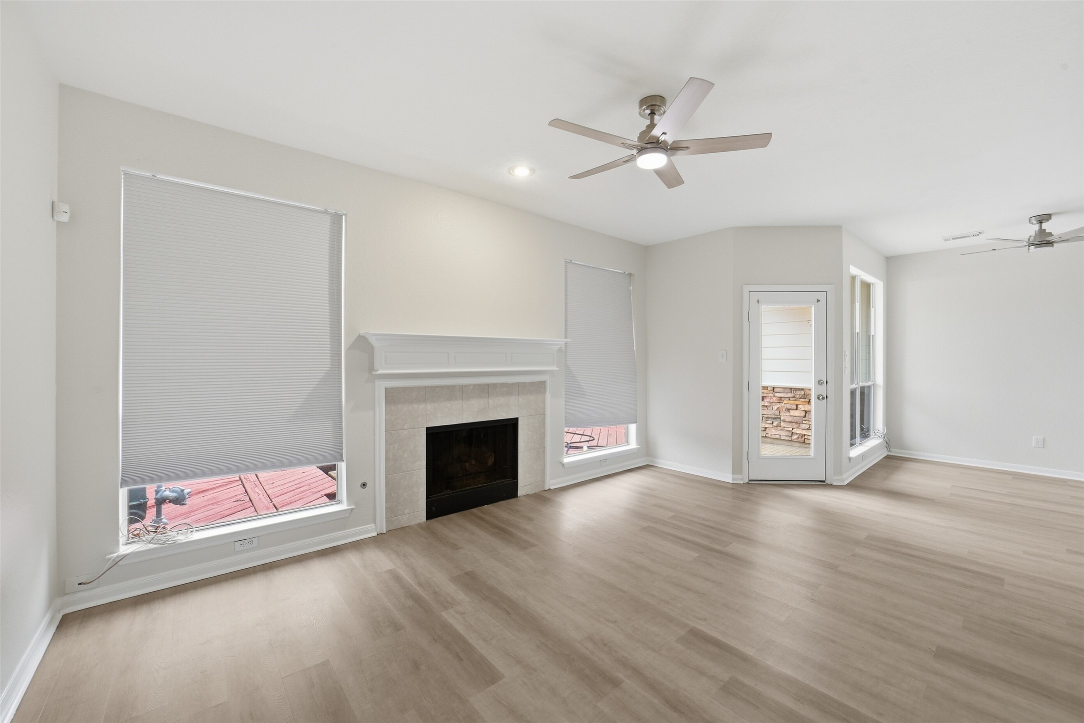 2110 Ridge Wood Lane Sugar Land, TX 77479 - Photo 5 of 26 a view of an empty room with wooden floor and a fireplace