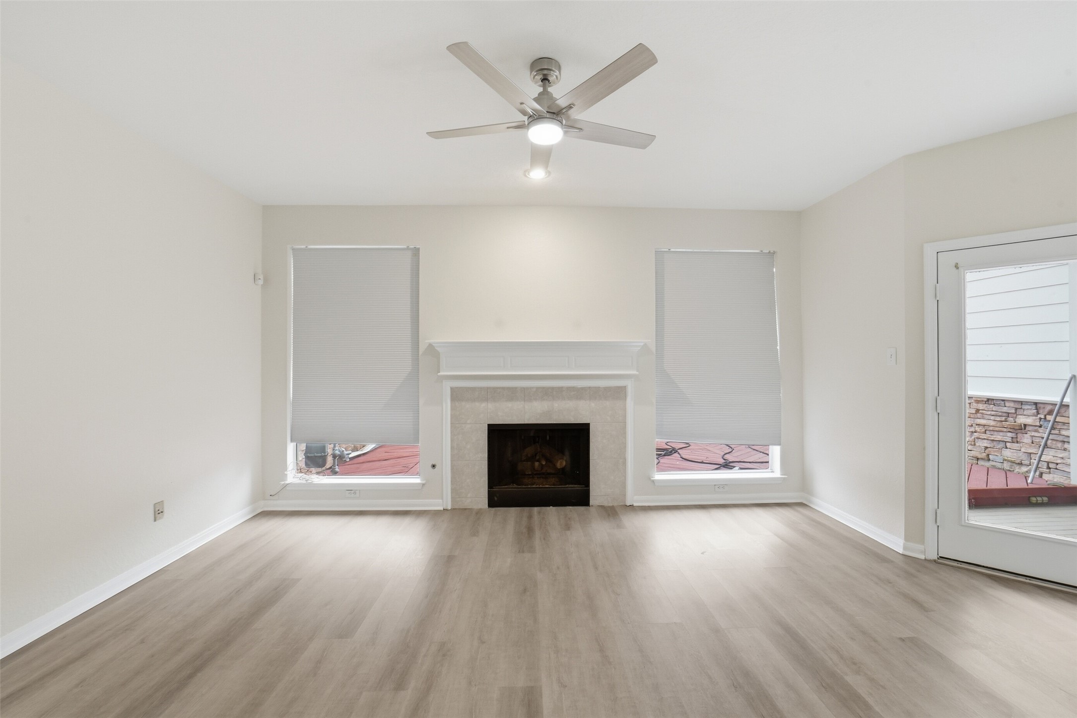 2110 Ridge Wood Lane Sugar Land, TX 77479 - Photo 6 of 26 an empty room with fireplace and wooden floor