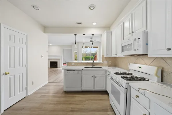 a kitchen with a sink cabinets and window