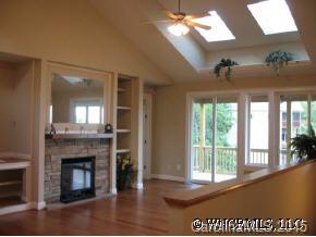 132 Sunny Ridge Road Hendersonville, NC 28739 - Photo 3 of 12 a view of a room with a fireplace wooden floor and windows