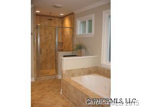 132 Sunny Ridge Road Hendersonville, NC 28739 - Photo 9 of 12 a bathroom with a bathtub and a shower