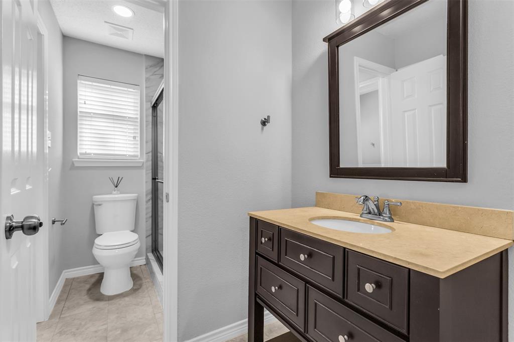 308 Glen Ridge Drive Murphy, TX 75094 - Photo 26 of 36 a bathroom with a sink vanity and a toilet