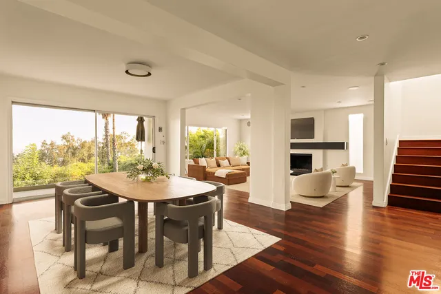 a view of a dining room with furniture window and wooden floor