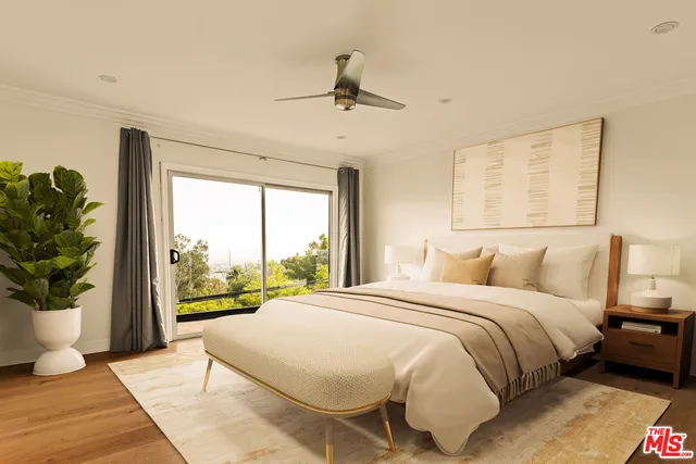 a bedroom with a bed and a large window