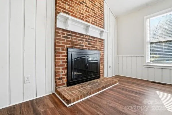 a view of a livingroom with a fireplace and window
