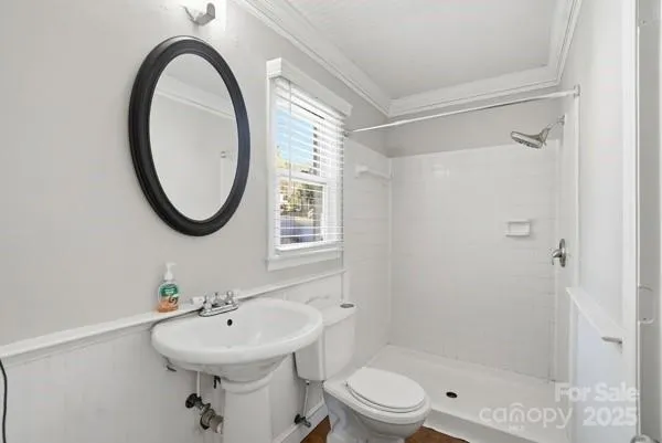 a bathroom with a sink toilet and a mirror