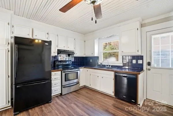 a kitchen with stainless steel appliances granite countertop a refrigerator stove and sink