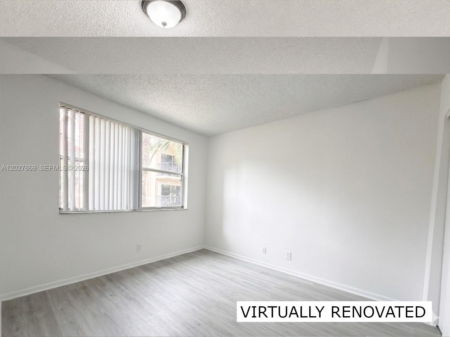 8761 Wiles Road, Unit 206 Coral Springs, FL 33067 - Photo 14 of 26 a view of an empty room with a window