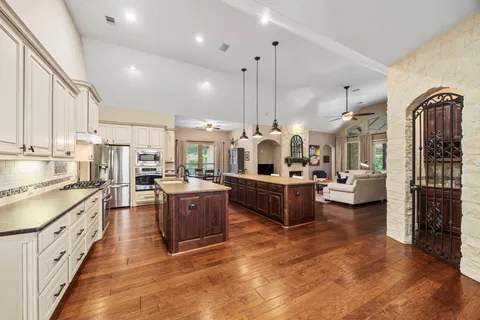 a large kitchen with stainless steel appliances kitchen island granite countertop a large counter top stainless steel appliances and cabinets