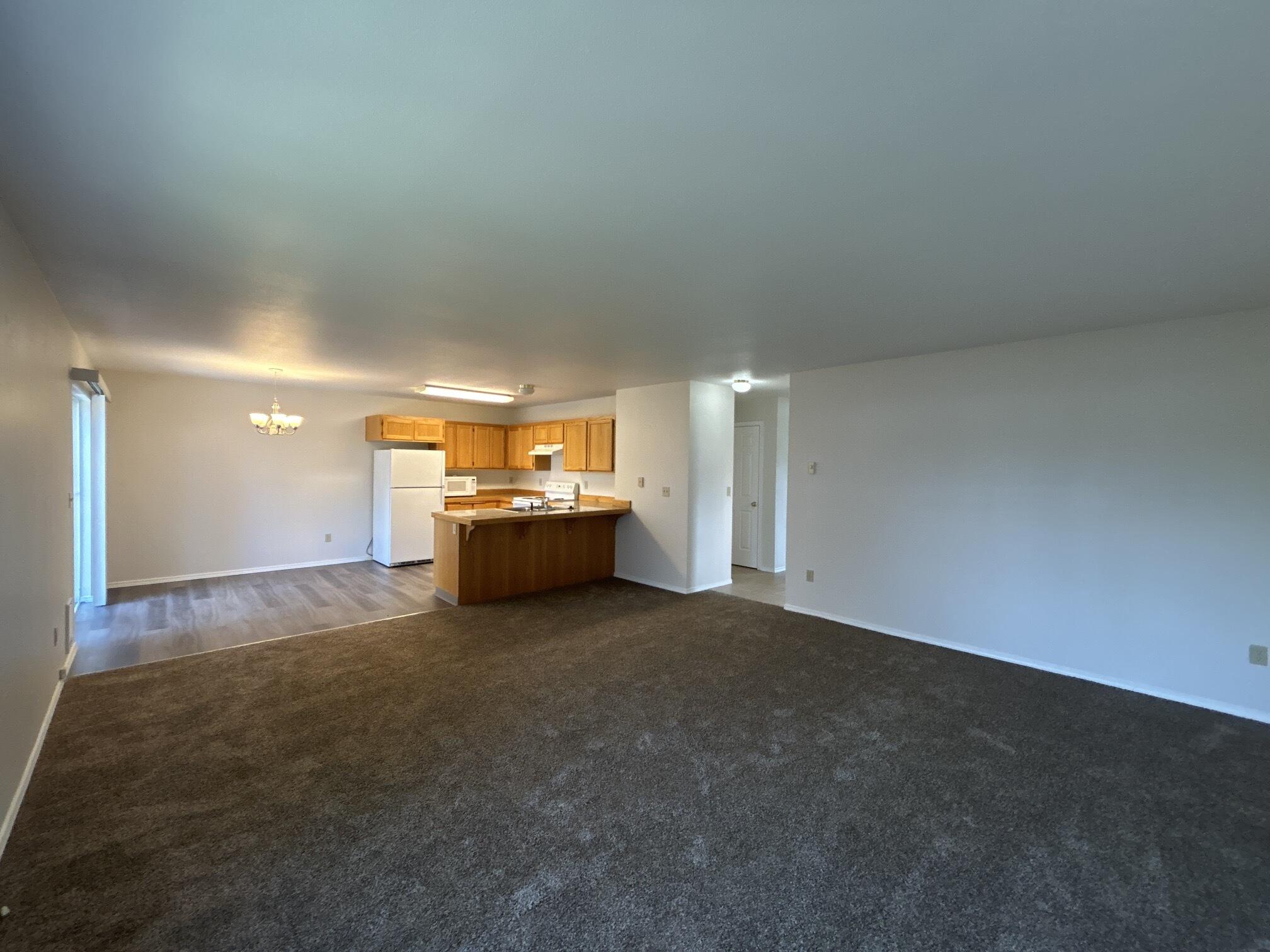 2211 Southwest Quartz Avenue Redmond, OR 97756 - Photo 2 of 26 a view of an empty room and a kitchen