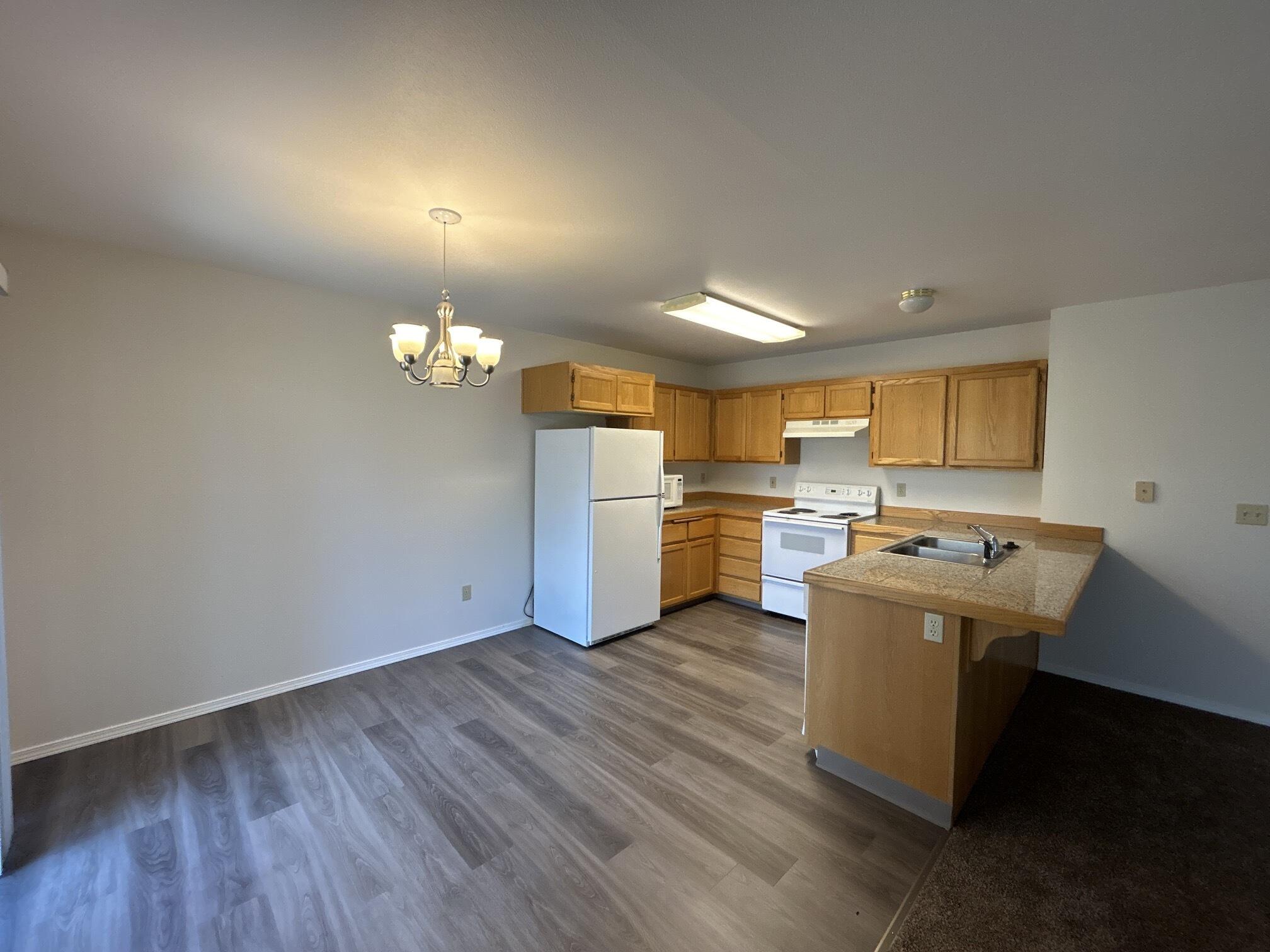 2211 Southwest Quartz Avenue Redmond, OR 97756 - Photo 4 of 26 a view of a kitchen with wooden floor