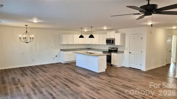 a kitchen with stainless steel appliances granite countertop a stove and a refrigerator