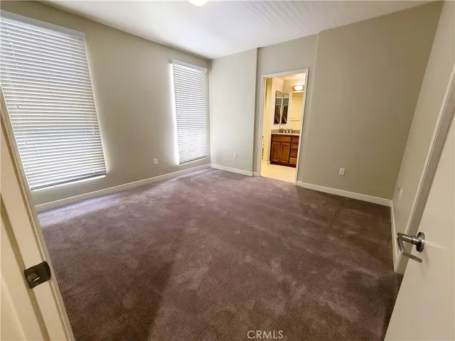 an empty room with closet and mirror