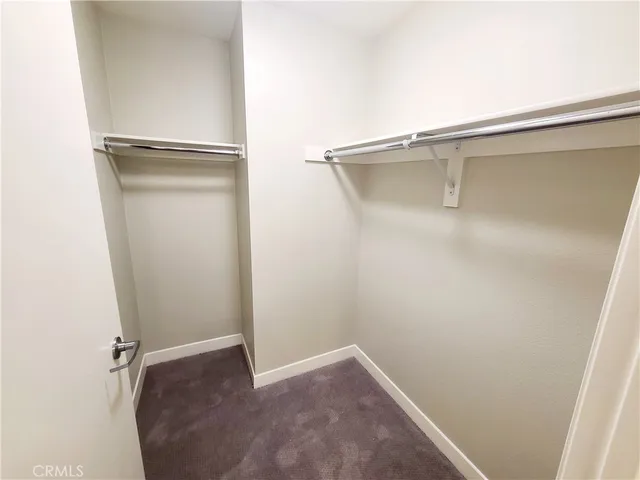 a bathroom with a granite countertop toilet sink and mirror