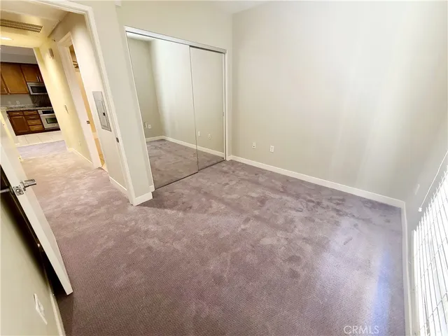 a bathroom with a granite countertop sink toilet mirror and bathtub