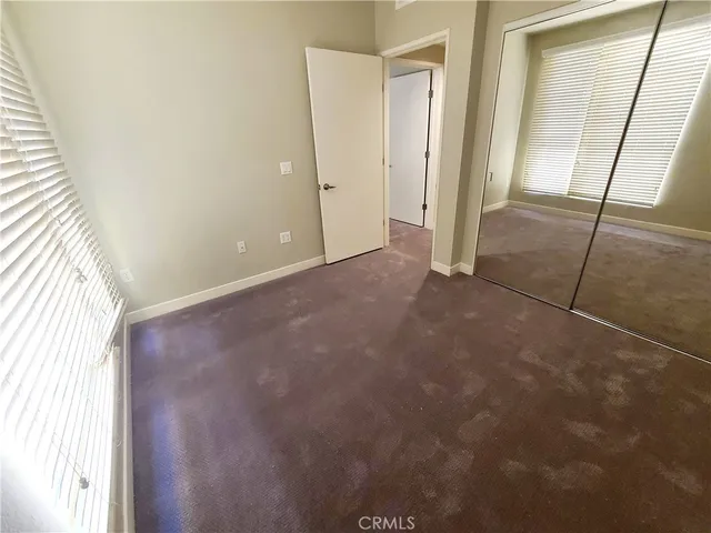 a bathroom with a granite countertop toilet sink and mirror