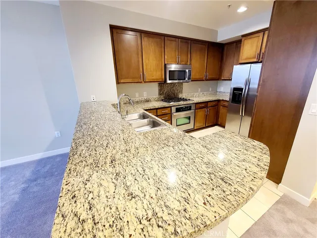 a view of a kitchen with a sink and cabinets