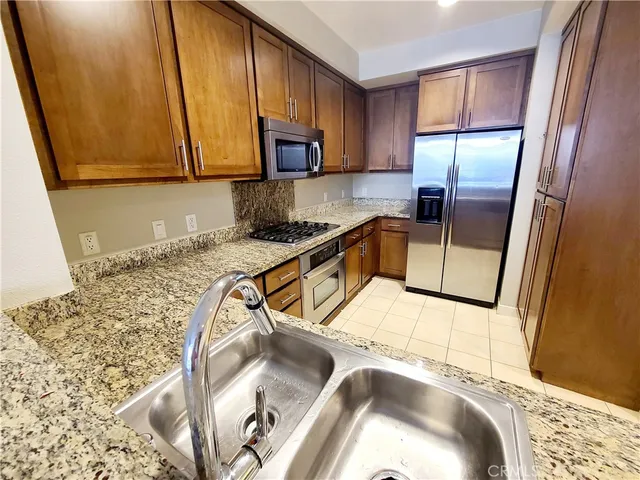 a bathroom with a granite countertop sink and a large mirror