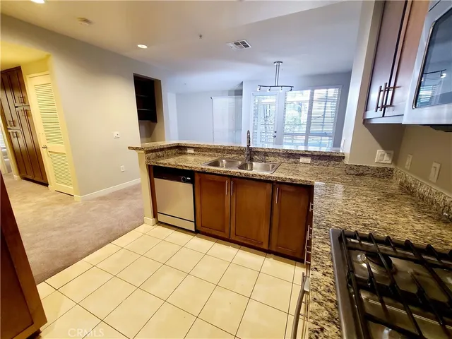 a view of a kitchen with a sink and cabinets
