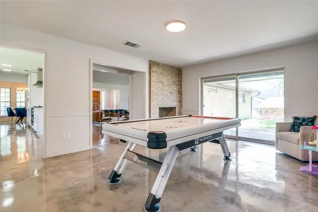 a room with dining table and windows