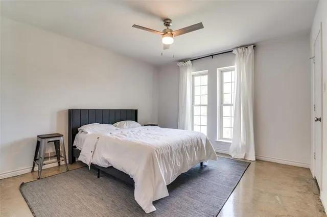 a bedroom with a bed and window