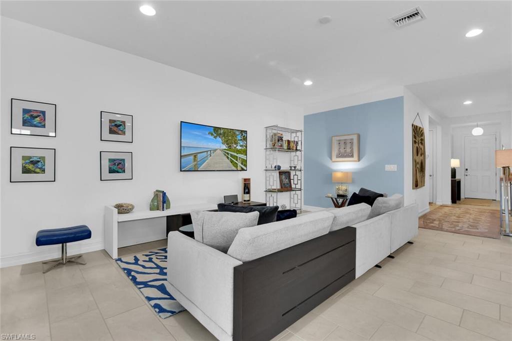 14662 Catamaran Place Naples, FL 34114 - Photo 11 of 44 a living room with furniture and a lamp