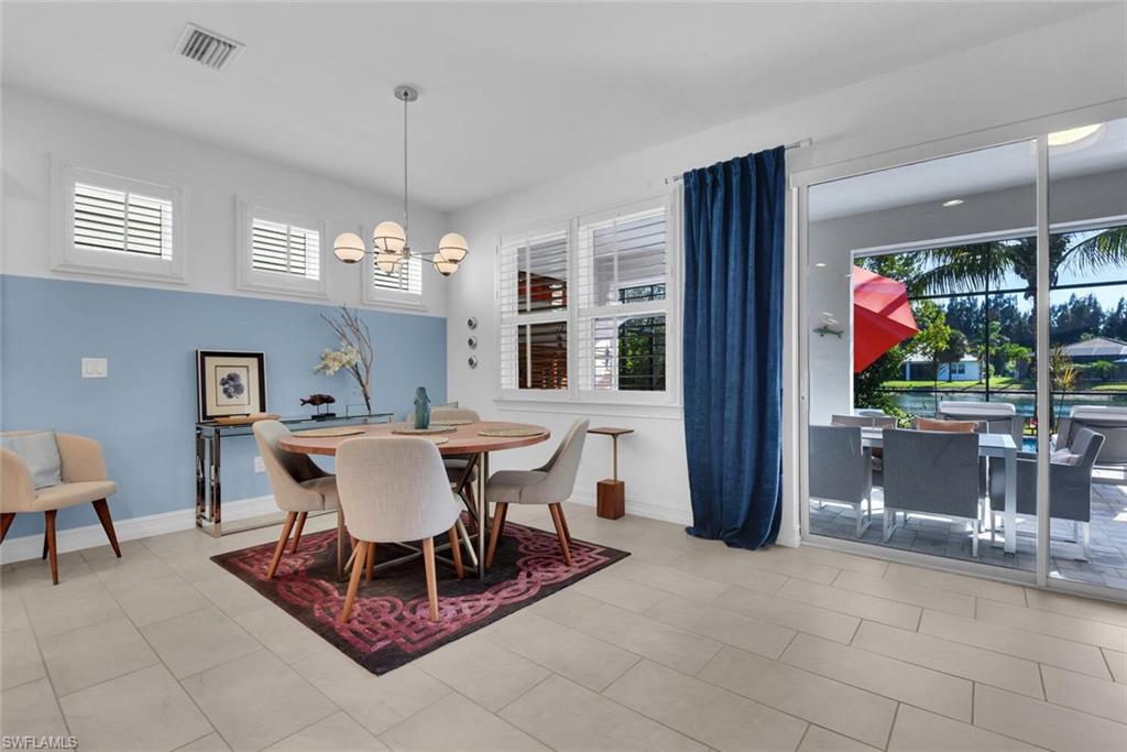 14662 Catamaran Place Naples, FL 34114 - Photo 12 of 44 a dining room with furniture a chandelier and window