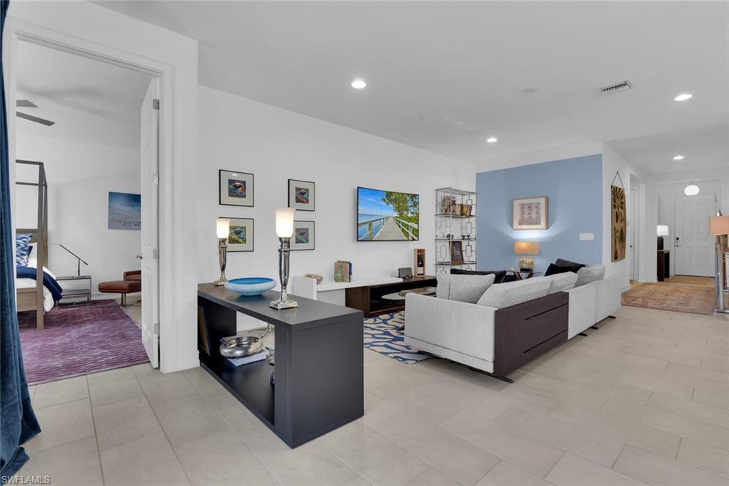 14662 Catamaran Place Naples, FL 34114 - Photo 13 of 44 a living room with furniture and wooden floor