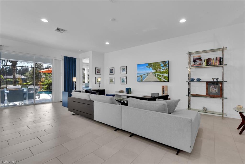 14662 Catamaran Place Naples, FL 34114 - Photo 14 of 44 a living room with furniture and a flat screen tv