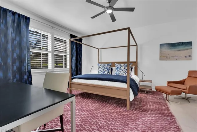 a bedroom with furniture and a window