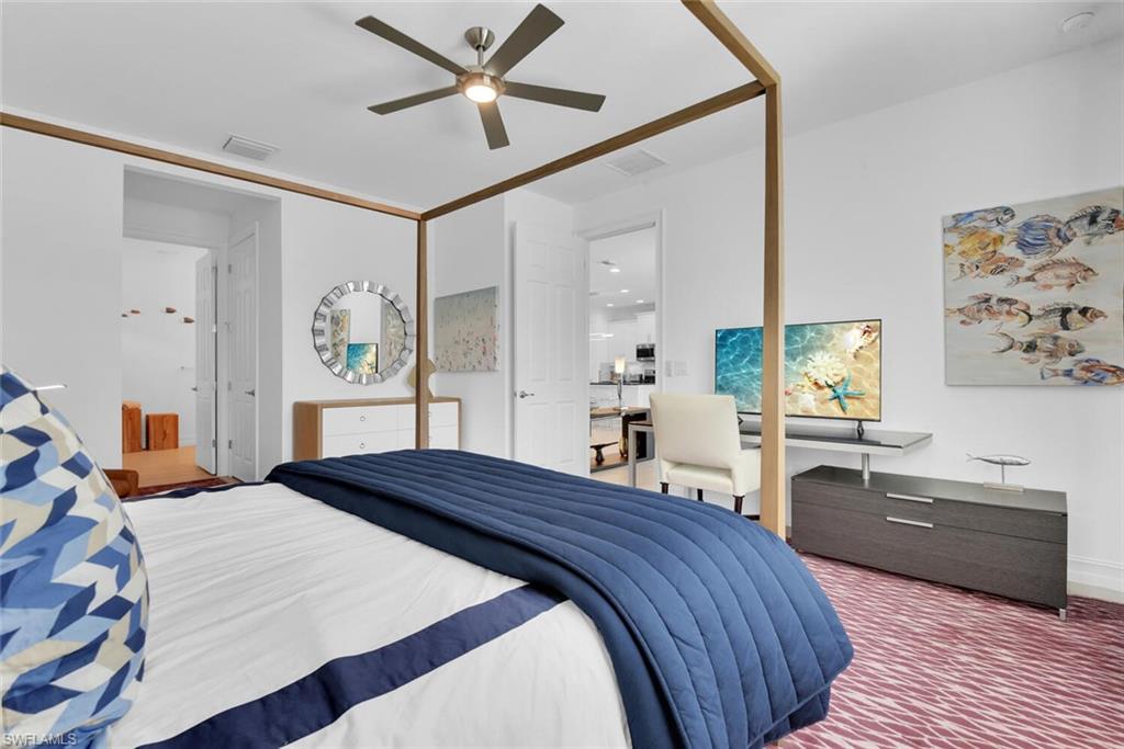 14662 Catamaran Place Naples, FL 34114 - Photo 16 of 44 a bedroom with a bed and a chandelier