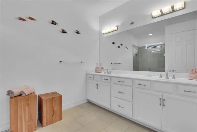 a bathroom with double vanity sink and mirror
