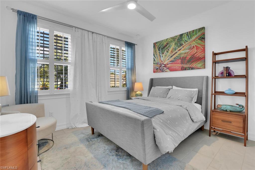 14662 Catamaran Place Naples, FL 34114 - Photo 20 of 44 a spacious bedroom with a bed and a painting on the wall