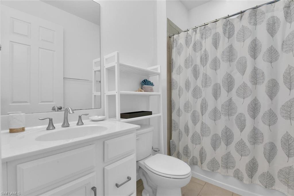 14662 Catamaran Place Naples, FL 34114 - Photo 22 of 44 a bathroom with a sink a toilet and shower curtain