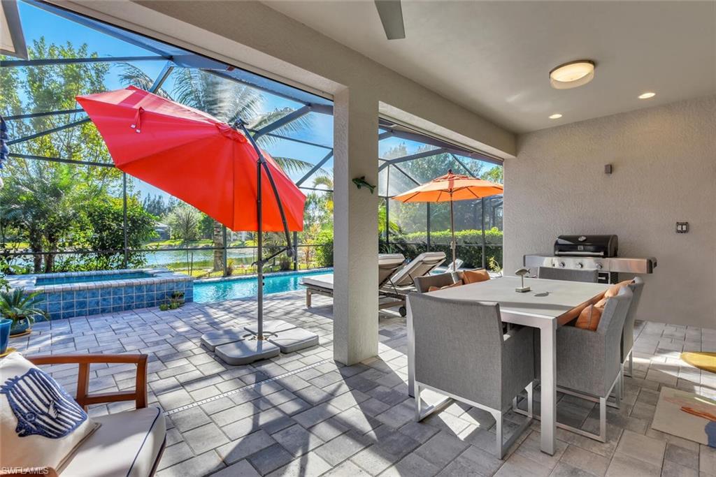 14662 Catamaran Place Naples, FL 34114 - Photo 26 of 44 a view of a patio with a table and chairs