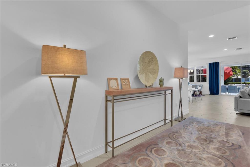 14662 Catamaran Place Naples, FL 34114 - Photo 3 of 44 a view of living room with furniture and a flat screen tv