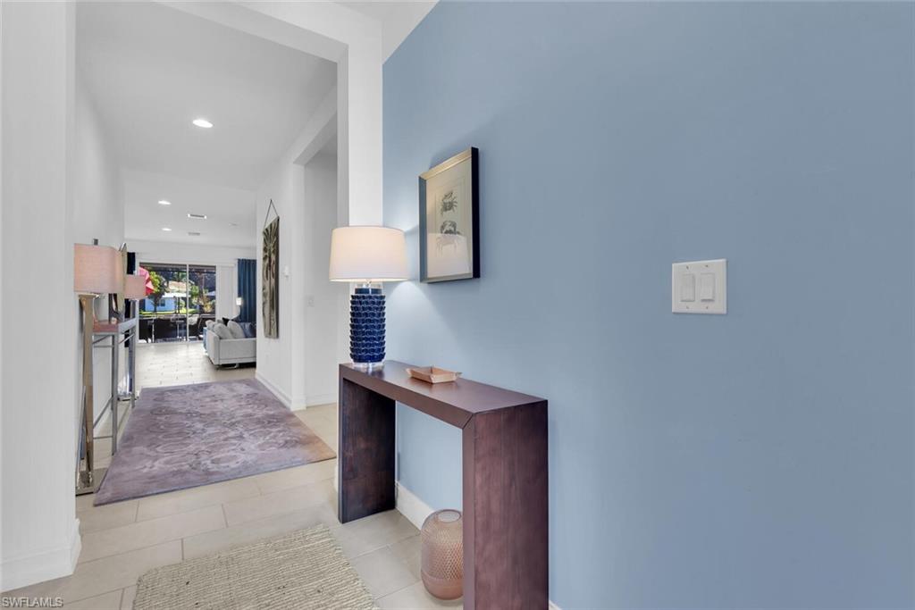 14662 Catamaran Place Naples, FL 34114 - Photo 4 of 44 a view of living room with furniture and a lamp