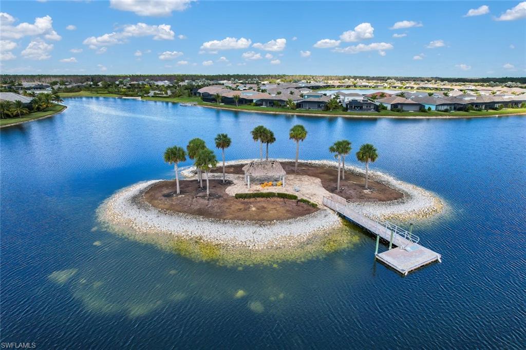 14662 Catamaran Place Naples, FL 34114 - Photo 41 of 44 a view of a lake with couches and city view