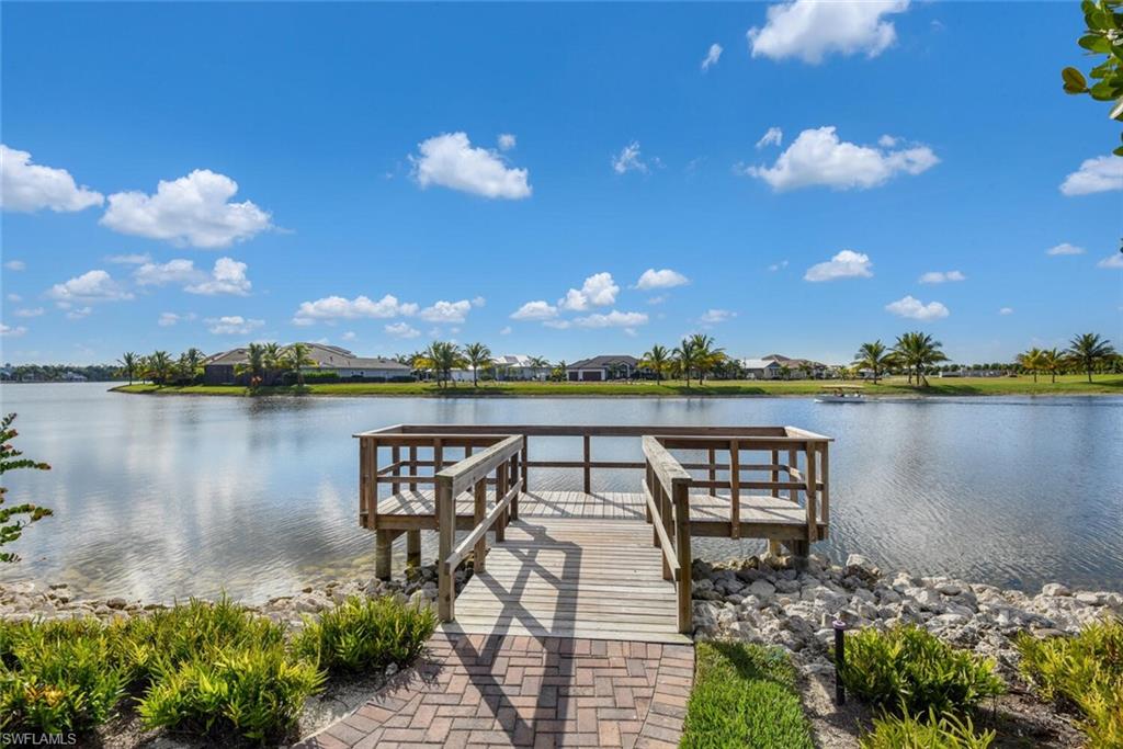 14662 Catamaran Place Naples, FL 34114 - Photo 44 of 44 a view of a lake with a table and a chairs