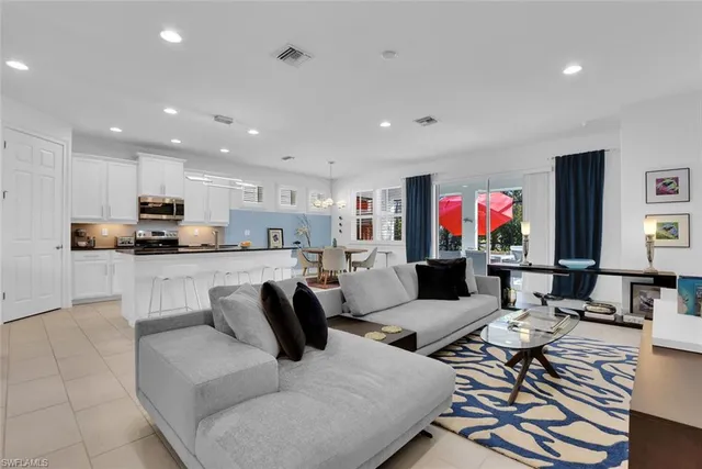 a living room with furniture and kitchen view