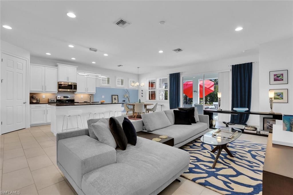 14662 Catamaran Place Naples, FL 34114 - Photo 5 of 44 a living room with furniture and kitchen view