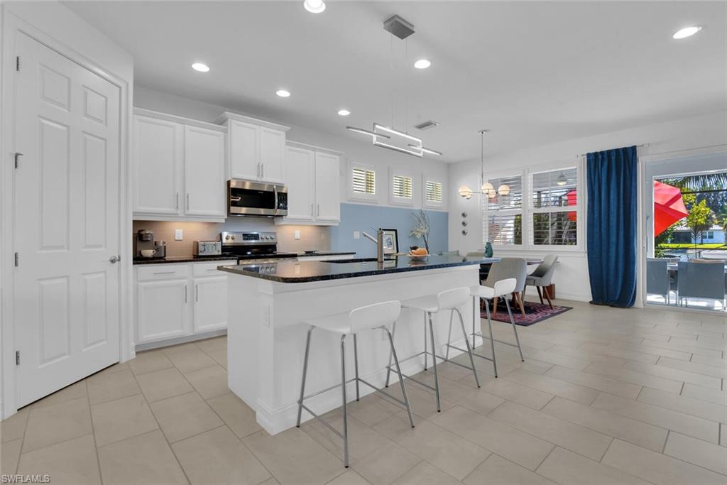 14662 Catamaran Place Naples, FL 34114 - Photo 6 of 44 a kitchen with a sink and cabinets