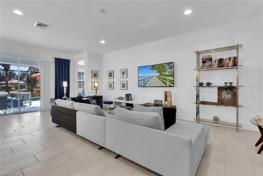14662 Catamaran Place Naples, FL 34114 - Photo 10 of 44 a living room with furniture and a flat screen tv
