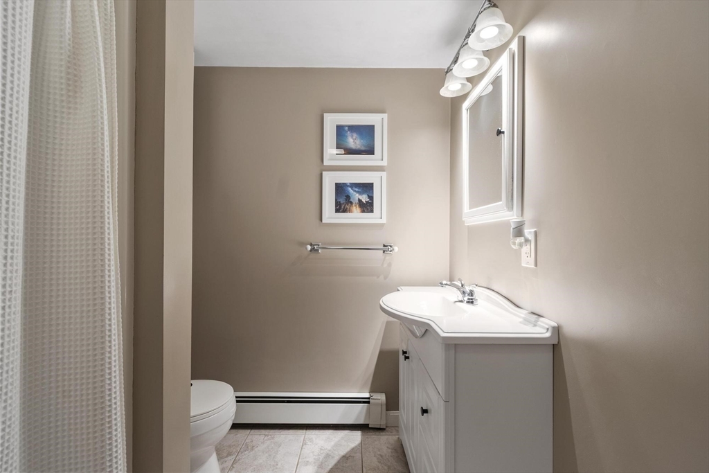 167 Gates Pond Road Berlin, MA 01503 - Photo 18 of 32 a bathroom with a sink toilet and vanity